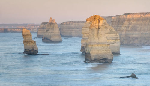 Scenic view of rocks in sea against sky