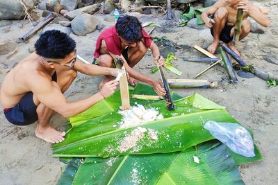 High angle view of people on wet shore