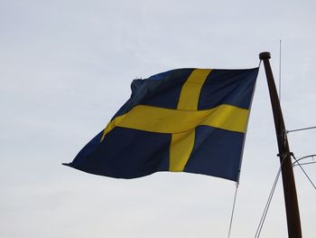 Low angle view of flag against sky