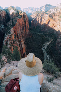 High angle view of woman sitting on cliff at zion national park