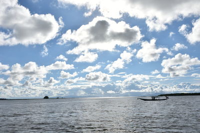 Scenic view of calm sea against cloudy sky