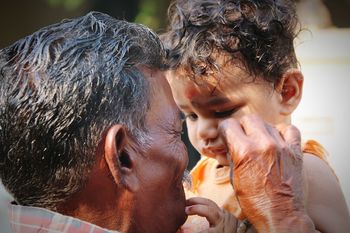 Close-up of grandfather with granddaughter