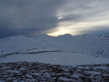 Scenic view of snow covered mountains against sky