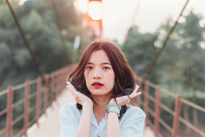 Portrait of a beautiful young woman standing outdoors