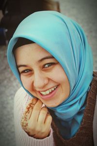 Close-up portrait of smiling young woman wearing hijab