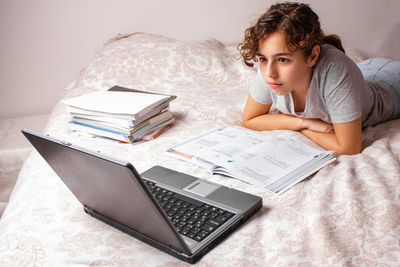 Boy lying down on bed