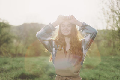 Portrait of young woman standing in forest