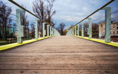 Surface level of empty footpath against sky