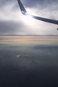 Cropped image of airplane flying over landscape