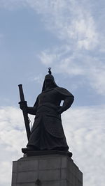 Low angle view of statue against sky