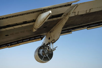 Low angle view of airplane against clear sky