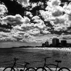 View of cityscape against cloudy sky