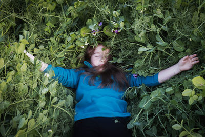 Midsection of woman with arms raised