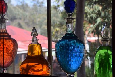 Close-up of bottles with liquids for sale in store