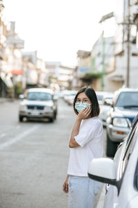 Full length of woman standing on street in city