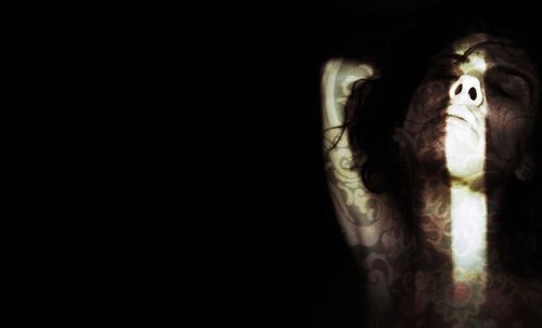 Close-up of illuminated lamp over black background