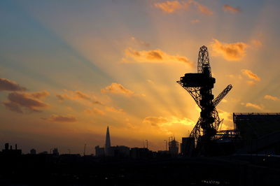 Low angle view of silhouette building against sky during sunset