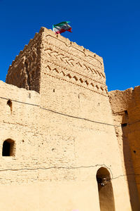 Low angle view of historical building against clear blue sky