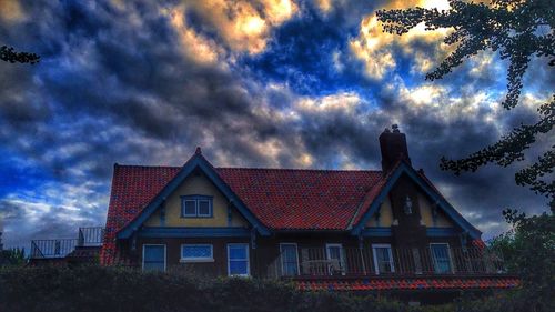 Low angle view of building against cloudy sky