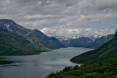 Scenic view of mountains against cloudy sky