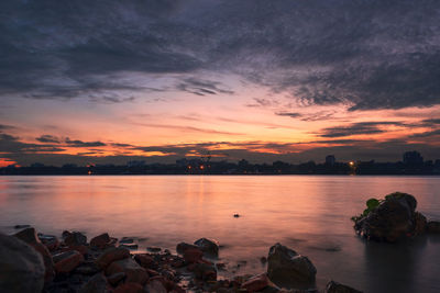 Scenic view of river against romantic sky at sunset