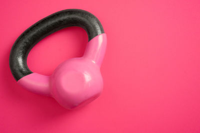 High angle view of kettlebell on pink background