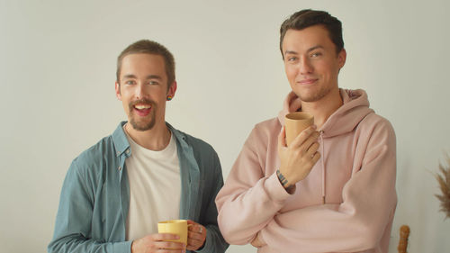 Smiling gay couple at home