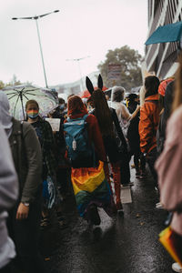 Group of people walking on wet street in rainy season