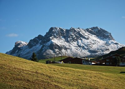 Scenic view of snow covered mountains against sky