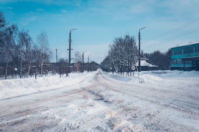 Snow covered road against sky