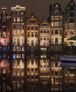 Reflection of buildings in city at night