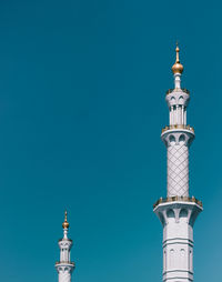 Low angle view of tower against blue sky