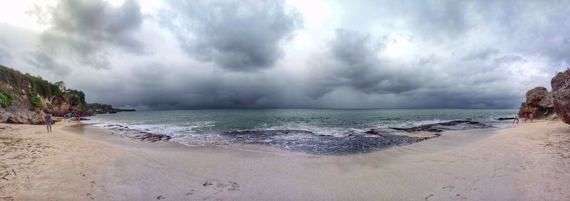 Panoramic view of sea against storm clouds