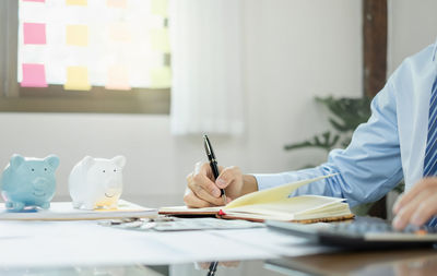 Midsection of architect working at office