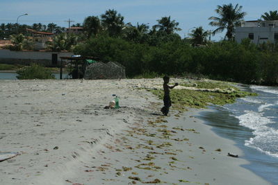 Side view of boy standing at beach