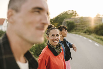 Smiling woman standing at roadside