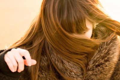Close-up of woman with hand hair