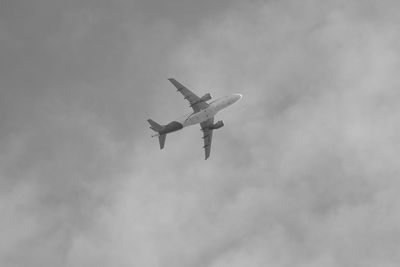 Low angle view of airplane flying in sky