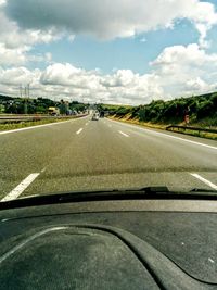 Empty road against cloudy sky