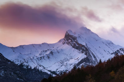 Scenic view of snowcapped mountains against sky during sunset