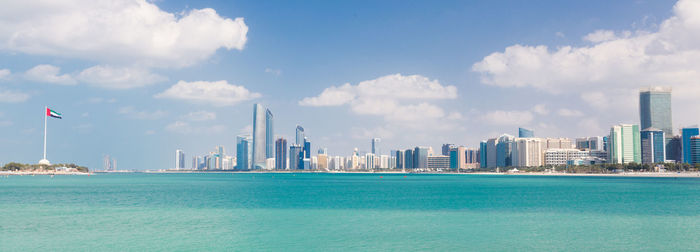 Panoramic view of sea and buildings against sky
