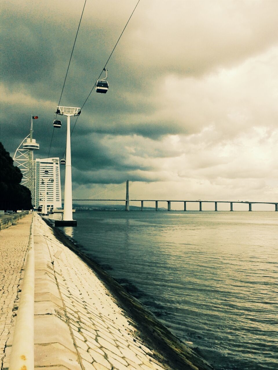 sky, sea, water, built structure, architecture, cloud - sky, transportation, connection, cloudy, pier, bridge - man made structure, cloud, building exterior, the way forward, nature, outdoors, engineering, waterfront, mode of transport, day