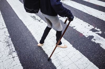 Low section of man crossing road