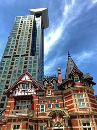 Low angle view of buildings against cloudy sky