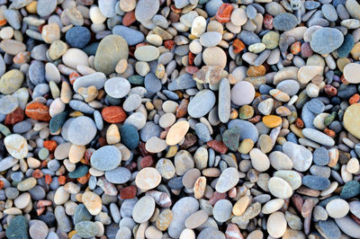 Colorful pebble stones texture by the beach