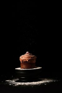 Close-up of cake against black background