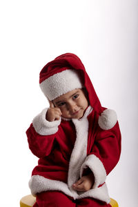 Portrait of boy wearing hat against white background