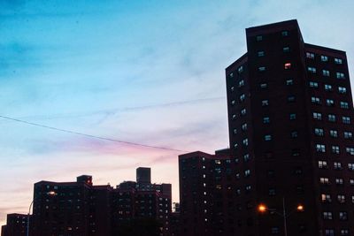 Low angle view of buildings against sky at dusk