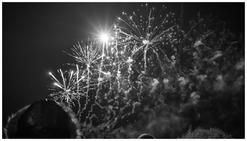 Low angle view of firework display at night