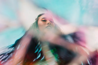 Portrait of multiracial female through cracked glass prism